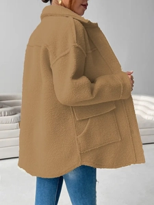 Detail of camel teddy fleece jacket showing plush texture and oversized patch pockets