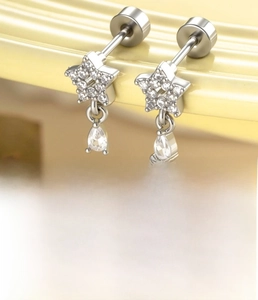 Macro view of silver star ear stud with micro-set zircon and teardrop pendant detail