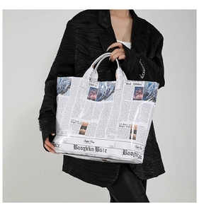 Macro detail of the newspaper print texture on the glossy waterproof tote bag