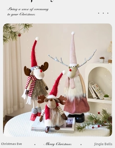 Detailed view of three festive reindeer plush dolls with knit scarves and fur trim