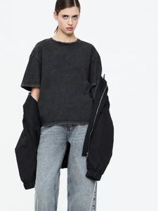 Inquadratura a corpo intero di t-shirt in cotone grigio scuro con jeans larghi blu