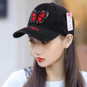 Asian model wearing black washed denim baseball cap with butterfly patch and embroidery