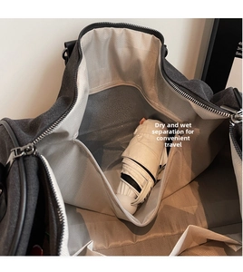 Detail of travel bag interior showing waterproof dry-wet separation pocket with white umbrella