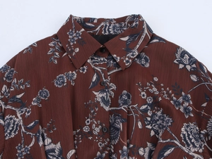 Detailed view of dark brown floral chiffon dress with textured stripes and lapel collar