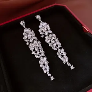 Sparkling silver flower drop earrings with rhinestones and tassels in a black gift box