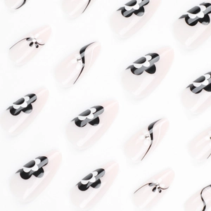 Short almond press-on nails with black flower patterns, silver rhinestones and stripes