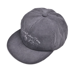 Close-up of cactus embroidery on dark grey corduroy flat brim baseball cap texture