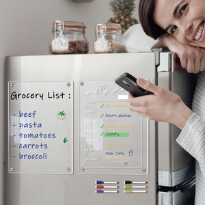 Clear acrylic weekly planner and grocery list with magnetic mounts on fridge