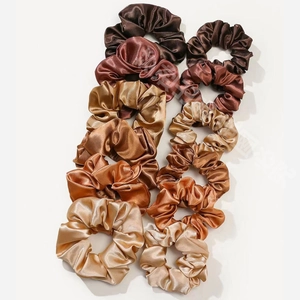 Close-up of silk satin scrunchies in brown, copper and gold tones, 12-piece variety set