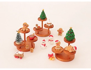 Miniature wooden tiered stand with resin gingerbread man, snowman and deer figurines