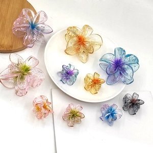 Transparent glitter frangipani flower hair claws in various gradient colors and sizes