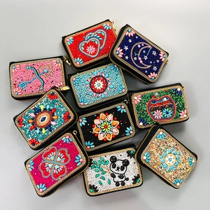 Handmade bohemian beaded card holder wallets with floral patterns and gold zippers