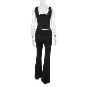 Rear view of black sleeveless top and flared trousers two-piece set on a mannequin