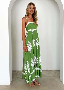 Detail of bohemian green floral maxi dress with delicate straps and wavy white trim