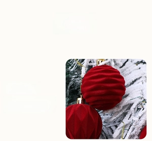 Detailed macro view of dark red flocked Christmas ball with velvet texture on a tree