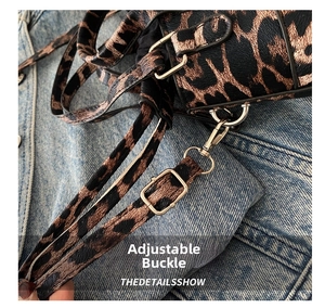 Detail of adjustable silver buckle and metal clasp on leopard print shoulder bag strap