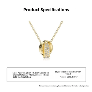 Close-up of interlocking double ring pendant with crystals and screw motifs in gold