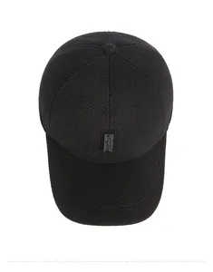 Detailed close-up of textured black winter baseball cap with mountain sports patch logo