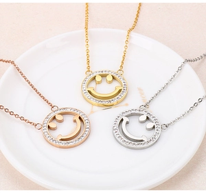 Detailed view of smiley face necklaces in gold silver and rose gold with rhinestones