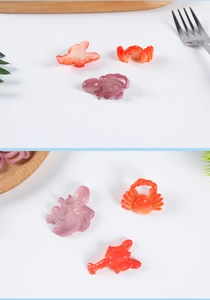 Macro detail of miniature PVC seafood models like octopus and crab for DIY decor