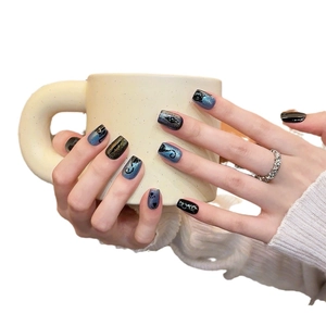 Cat-themed blue and black cat-eye press-on nails with glitter feline silhouettes