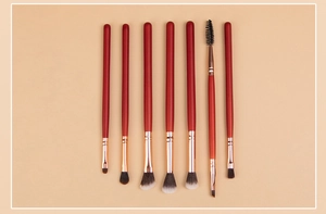 Detail of 7-piece makeup brush set with red handles and rose gold ferrules