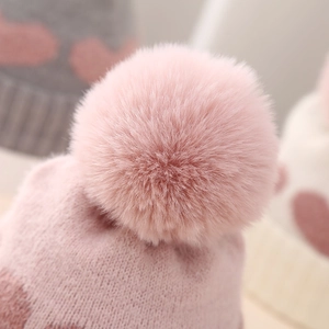 Winter newborn baby knit hat with pink jacquard heart pattern and large faux fur pompom