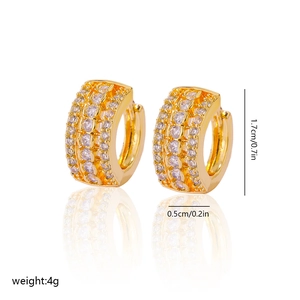 Close-up of gold chunky hoop earrings featuring triple rows of clear cubic zirconia stones
