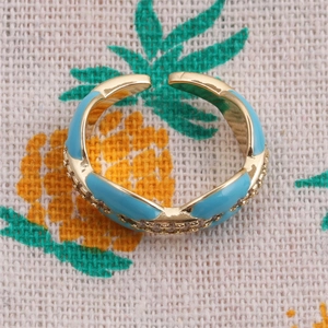 Macro shot of sky blue enamel ring band with sparkling micro-pave cubic zirconia accents