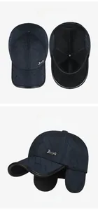 Detail of dark blue winter baseball cap with diamond quilting and fold-down ear flaps