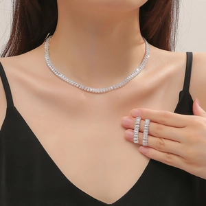 Detailed view of elegant silver bridal jewelry set with baguette-cut cubic zirconia