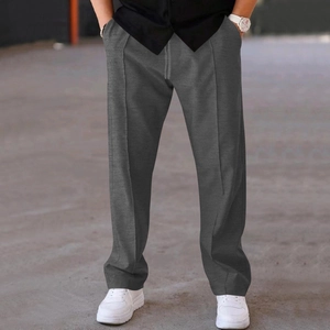 Detail of men's grey straight-leg casual pants with front crease design and drawstring
