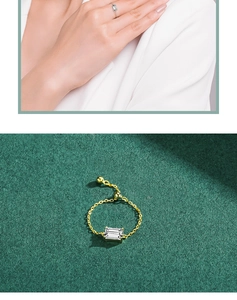 Detailed view of a gold chain ring with a rectangular gemstone and adjustable slide buckle