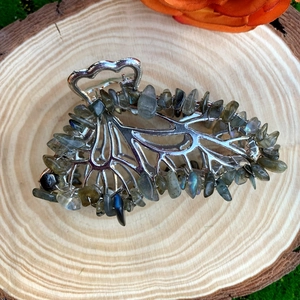 Detailed close-up of a silver butterfly hair clip with natural labradorite crystal stones