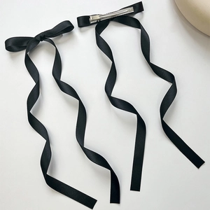 Pair of black ribbon bow hair clips with long streamers and metal duckbill clip