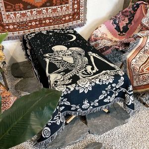 Detail of woven camping blanket with Gothic skull lovers, roses and fringe edges