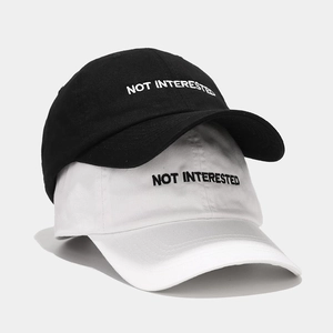 Classic cotton baseball caps in black and white with Not Interested embroidery detail