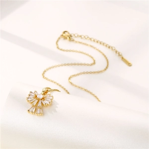 18k gold plated stainless steel bow necklace with zircon pendant on white background