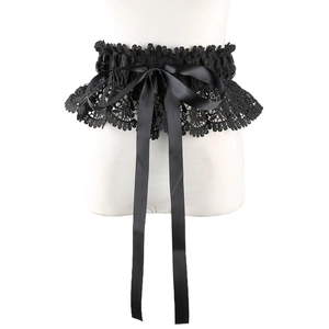 Detail of gothic black lace corset belt featuring a large satin ribbon bow on a mannequin