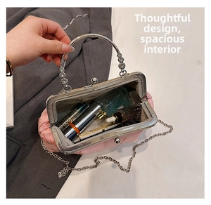 Pink silk evening bag interior with metal clasp, showing cosmetics and silver handle