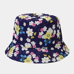 Detail of floral bucket hat showing navy blue fabric and colorful small flower pattern