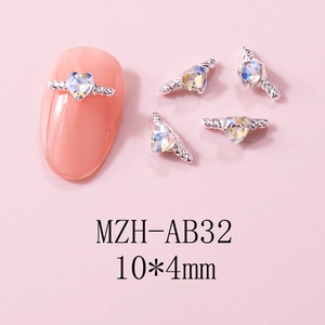 Macro detail of 10x4mm aurora heart nail charms with silver metal spiral texture