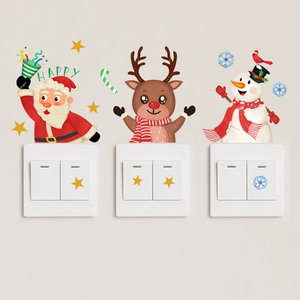 Luminous Santa Claus and reindeer stickers glowing on a white light switch