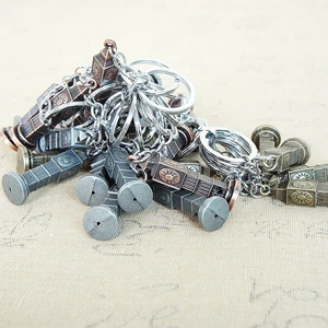 Detailed view of tower-shaped metal alloy keychains in bronze and silver finishes