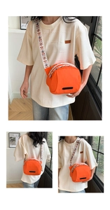 Detail of waterproof orange nylon crossbody bag with ethnic embroidered wide strap