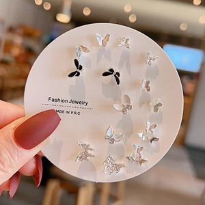 Detailed view of silver and black enamel butterfly stud earring set on a card
