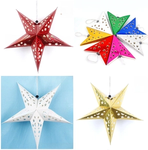 Detail of laser-cut hanging star ornaments with celestial patterns for holiday decor