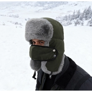 Detail of dark green winter trapper hat with gray faux fur lining and matching face mask