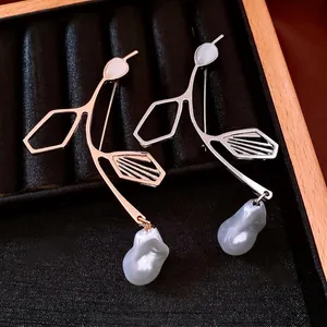French vintage irregular pearl brooches in rose gold and silver on black velvet display
