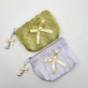 Pastel lace cosmetic bags with pearls and bows in light green and purple colors